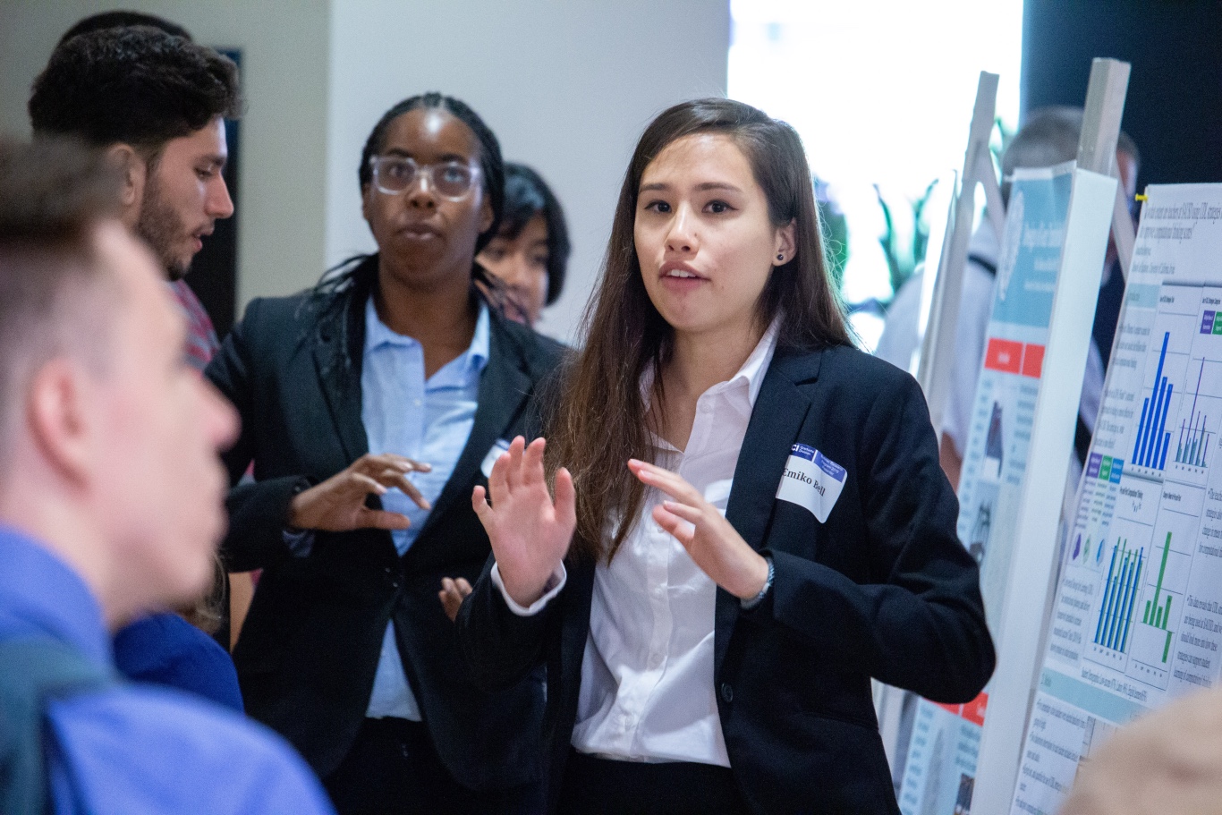 Emiko Bell explains an academic poster